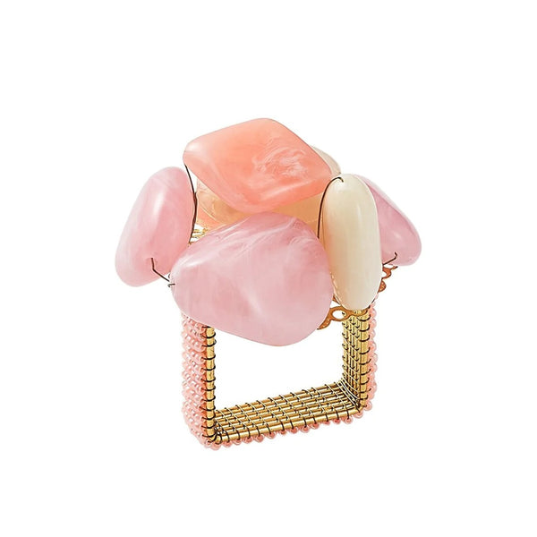 Sea Stone Napkin Ring in blush by Kim Seybert on white background with blush and cream resin stones in a beaded cluster design