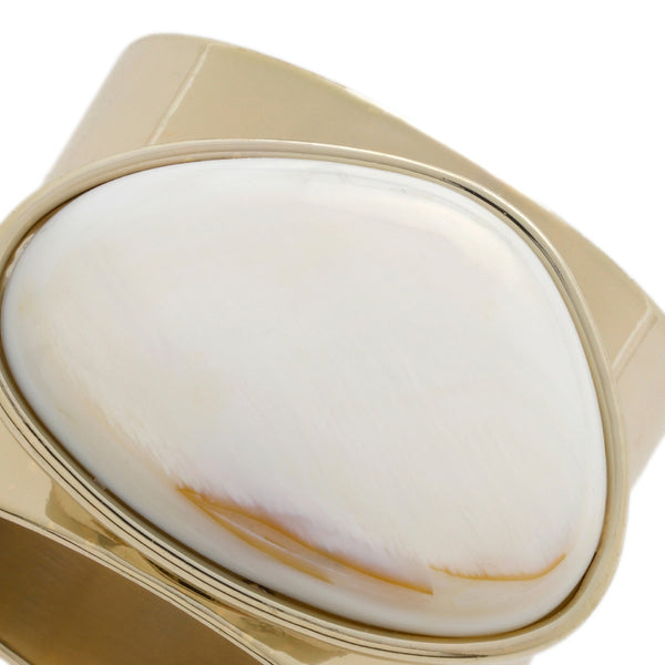 Close-up of gold-edged mother of pearl napkin ring showing natural texture and iridescence