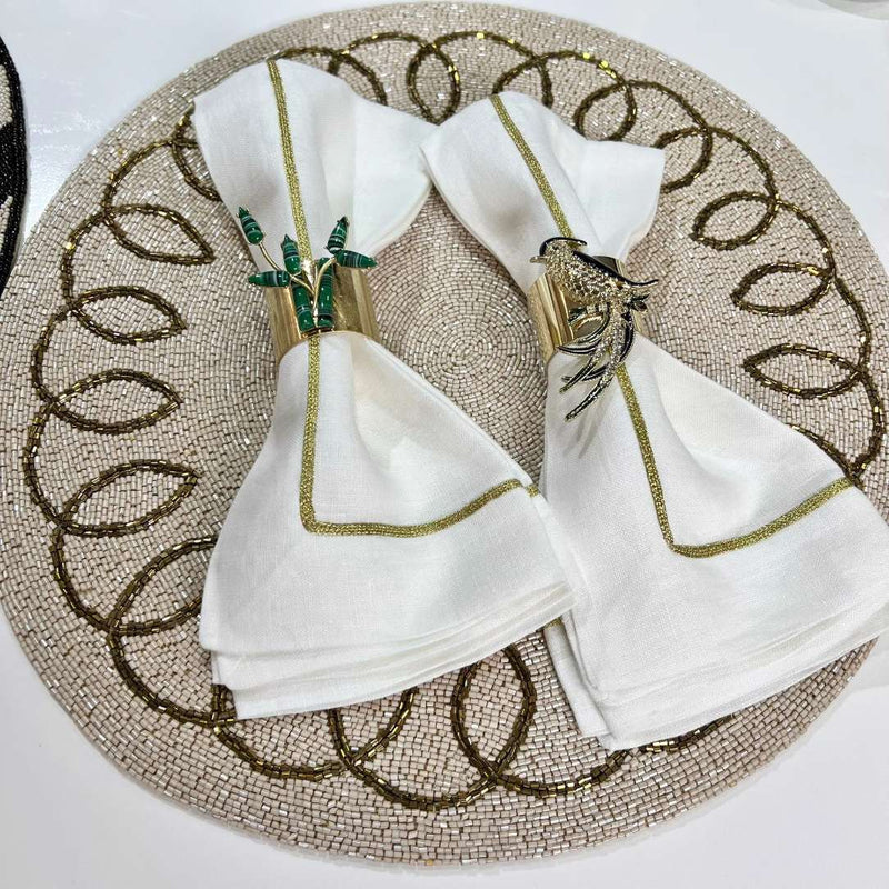 Bamboo napkin ring by Joanna Buchanan styled with white napkin on beaded placemat.