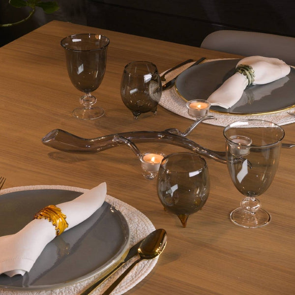 Amiramour Casarialto coloured leaves napkin rings in borosilicate glass, styled on an elegant table.