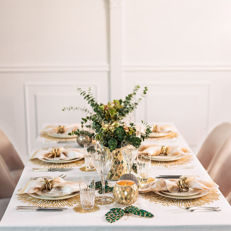 Luxury garden-inspired table setting from The Butterfly Effect by Amiramour with green butterfly decorations and golden mosaic vases.
