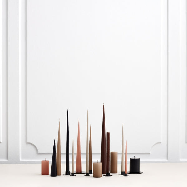 various cone and taper candles in brown, black and soft neutrals