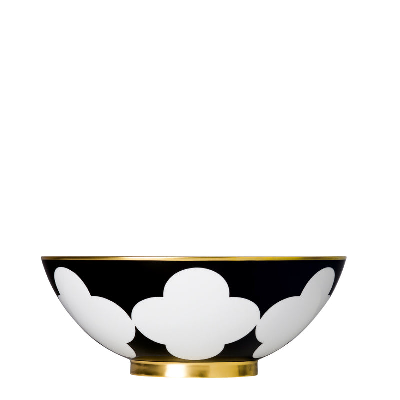 A white and gold porcelain bowl with a black geometric pattern and gold rim.