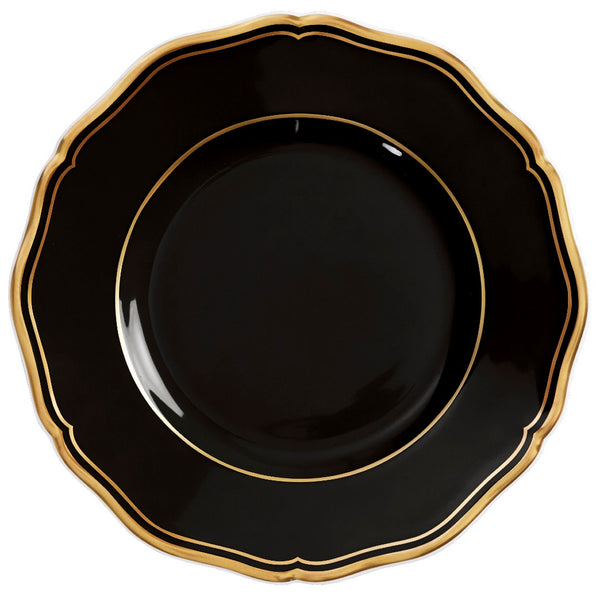 A porcelain bread and butter plate with scalloped edge black finish and gold rim from mazurka gold and black by raynaud