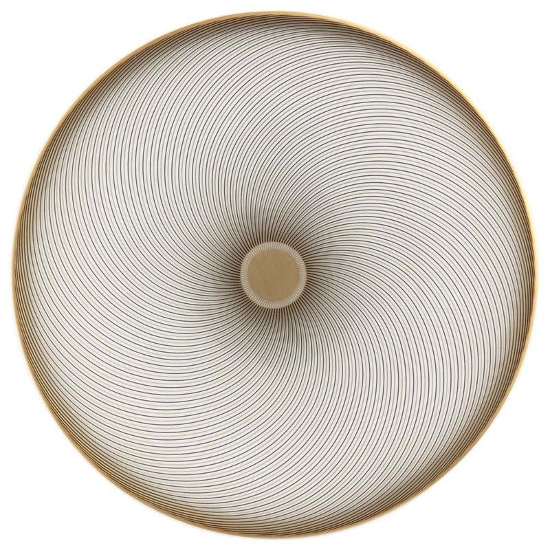 A top view of a round porcelain bread plate with a geometric pattern consisting of opposing curves in gold and intense black, with a beige center.