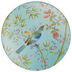 A porcelain plate with a turquoise rim and a central motif of a bird surrounded by floral and foliage designs.