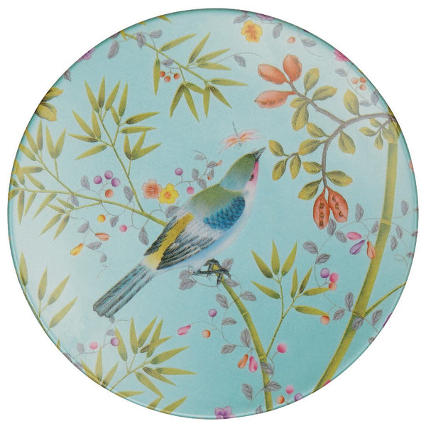 A porcelain plate with a turquoise rim and a central motif of a bird surrounded by floral and foliage designs.