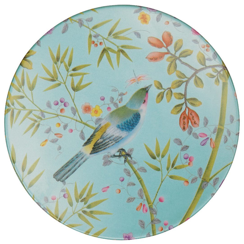 A porcelain plate with a turquoise rim and a central motif of a bird surrounded by floral and foliage designs.