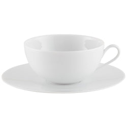 A white porcelain cup with a saucer from the "Uni" Collection by Raynaud.