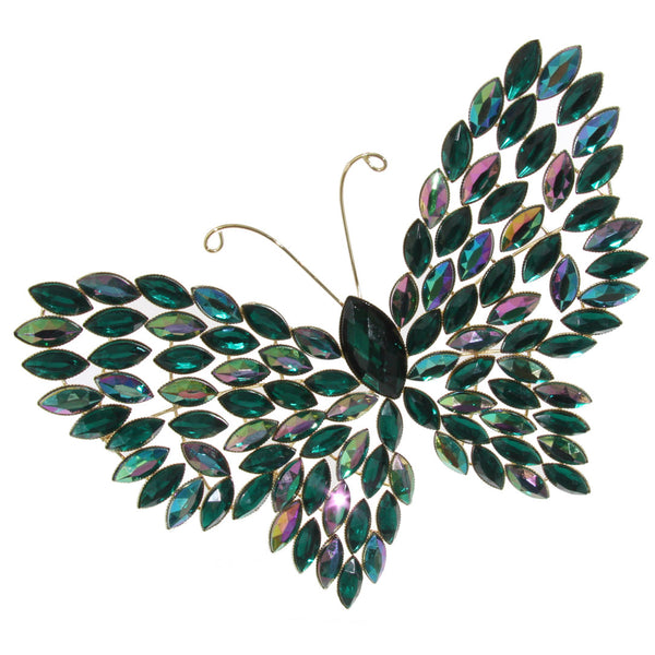 A decorative butterfly with gold body and green crystals wings.