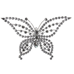 A silver and clear bejewelled butterfly decoration with intricate patterns and sparkling crystals.
