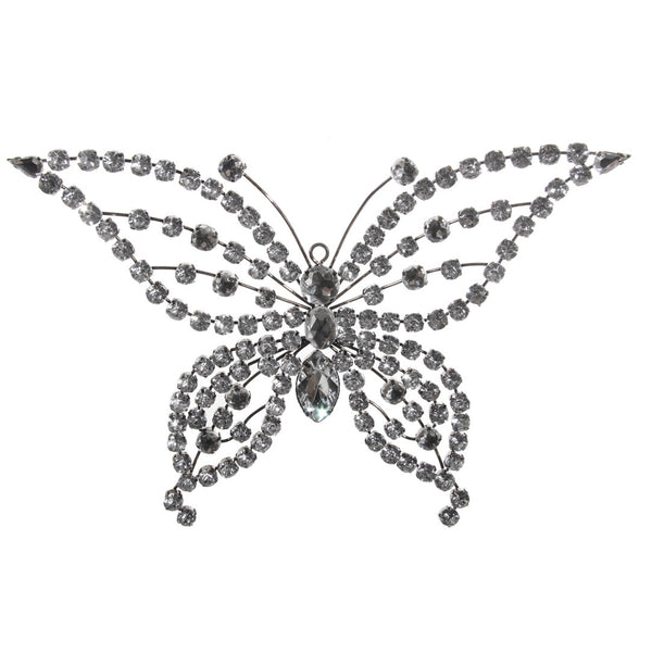 A silver and clear bejewelled butterfly decoration with intricate patterns and sparkling crystals.