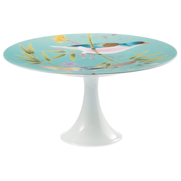 A medium-sized turquoise and white porcelain cake stand with floral and bird patterns, featuring a round shape and a white base.