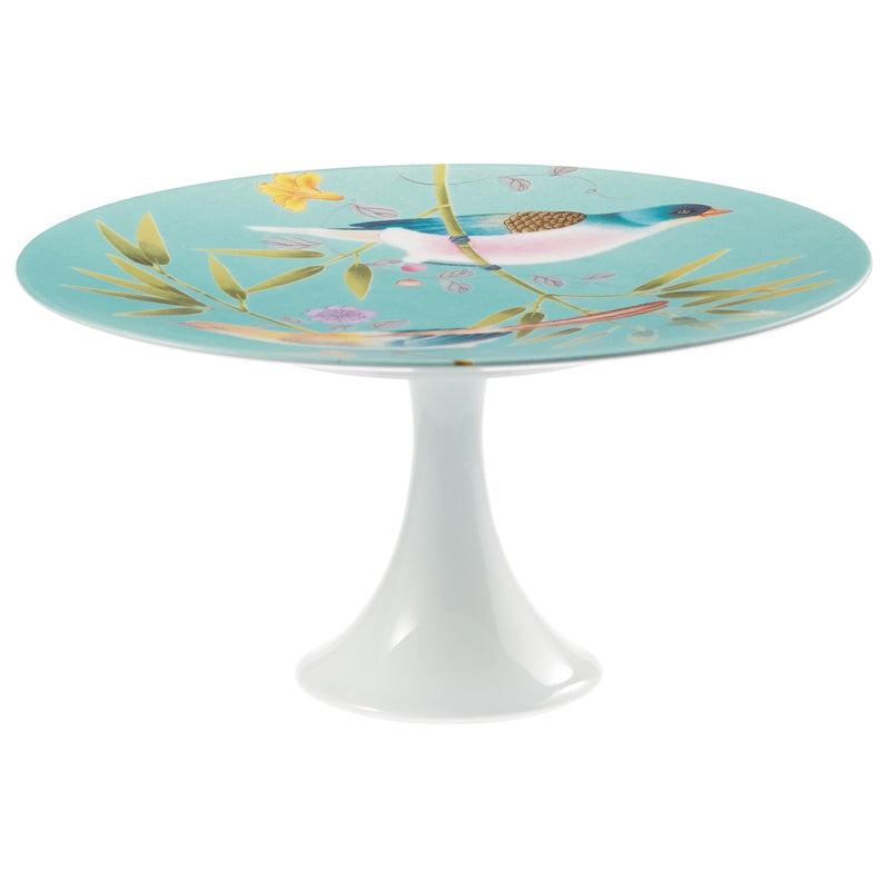 A medium-sized turquoise and white porcelain cake stand with floral and bird patterns, featuring a round shape and a white base.