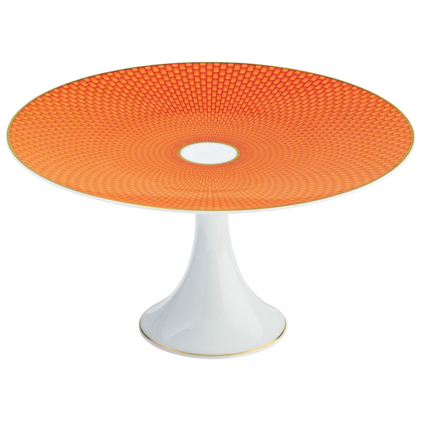 A round orange porcelain cake stand with a honeycomb pattern and a white base.