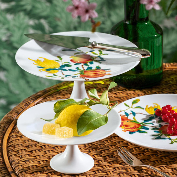 Styled table with the Harmonia luxury porcelain petit four cake stand small with fruit and floral motifs inspired by Chinese imperial art by Raynaud