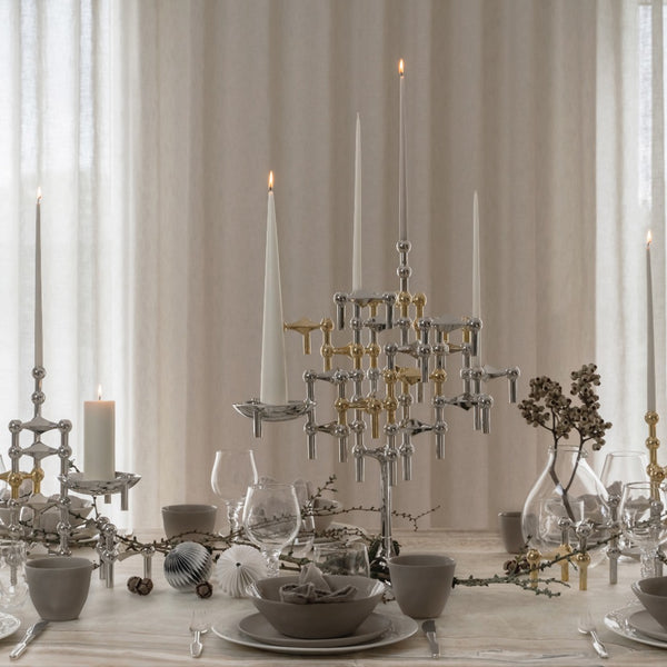 decorated moden table with the Chrome  and brass candle stand and holder by Stoff Nagel