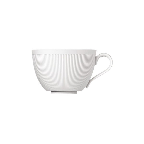 A white porcelain cappuccino cup with gentle relief lines and a heart-shaped handle, part of the Stella Satin White series by Sieger by Fürstenberg.