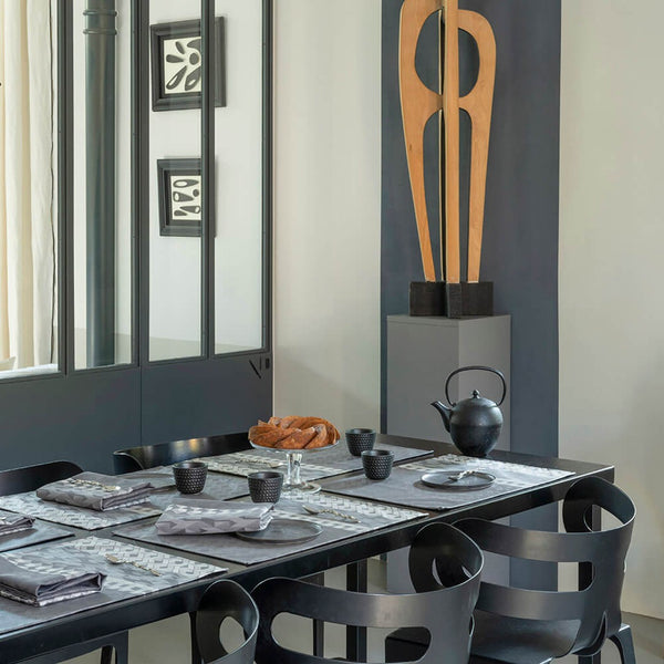 Grey modern dining room featuring grey geometric tableware