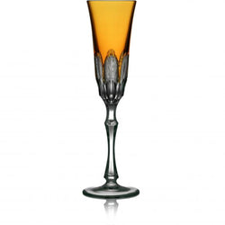 An amber-colored champagne flute with a traditional cutting technique, part of the Captiva Collection.