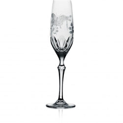 A clear champagne flute with hand-engraved springtime creatures and a flat cut base, made from hand-cut, hand-engraved art crystal.