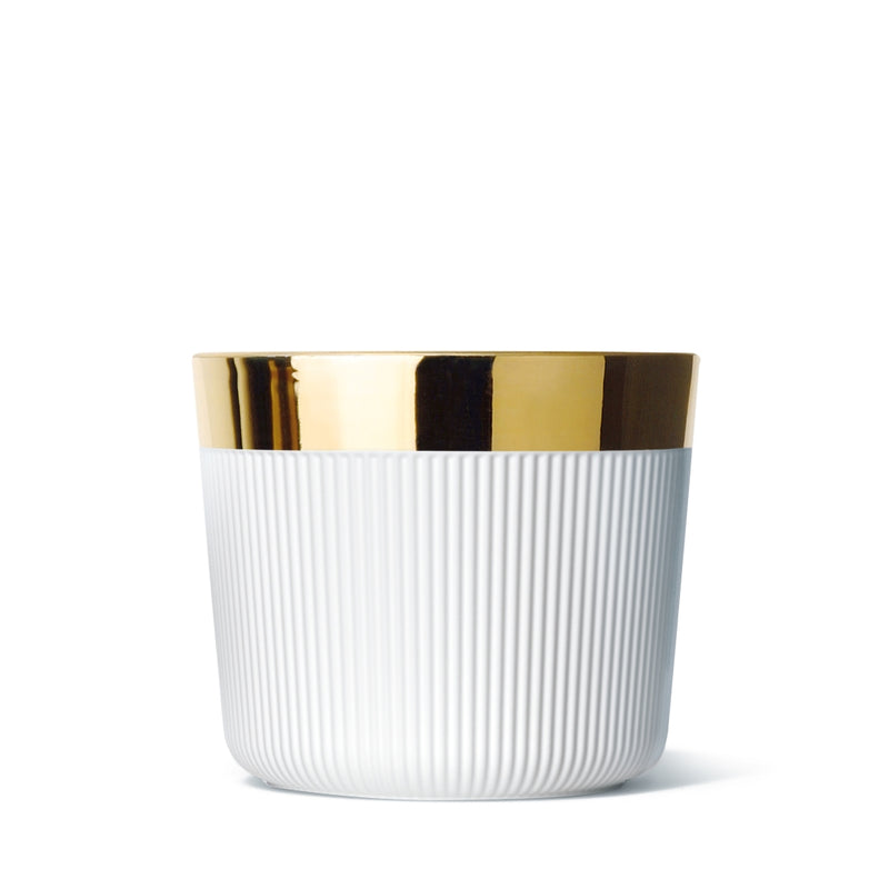 A white porcelain champagne goblet with gold detailing on the rim and interior.