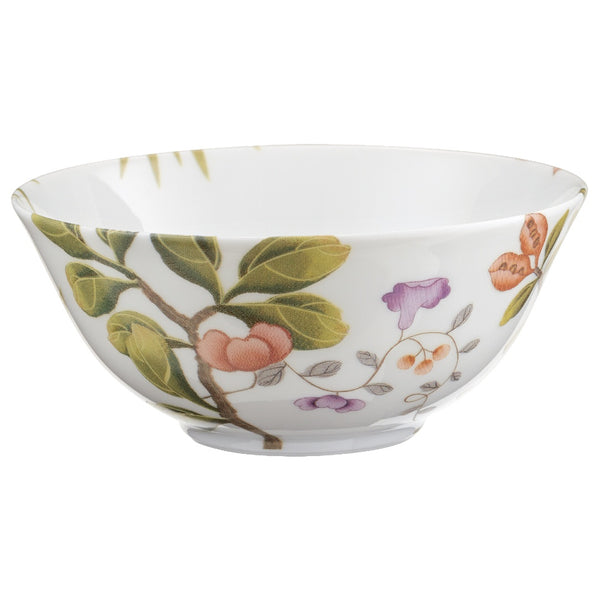 A white porcelain soup bowl with green and brown floral patterns and a bird motif.