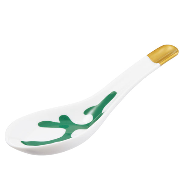 A white porcelain spoon with emerald and gold accents, featuring an organic branch-like design.