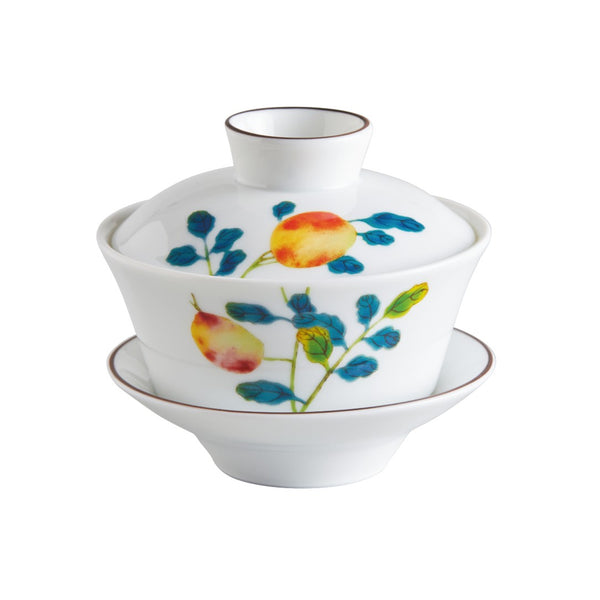 A Raynaud 'Harmonia' porcelain chinese tea set with a cup, lid, and saucer featuring colorful floral patterns.