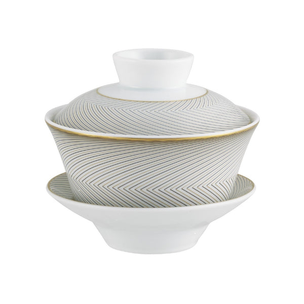 A Raynaud porcelain tea set with black and gold geometric patterns on a white background, including a taller cup and a shorter bowl.