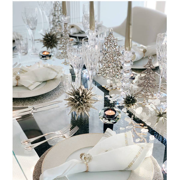 Styled festive table in white and silver featuring bejewelled Christmas tree