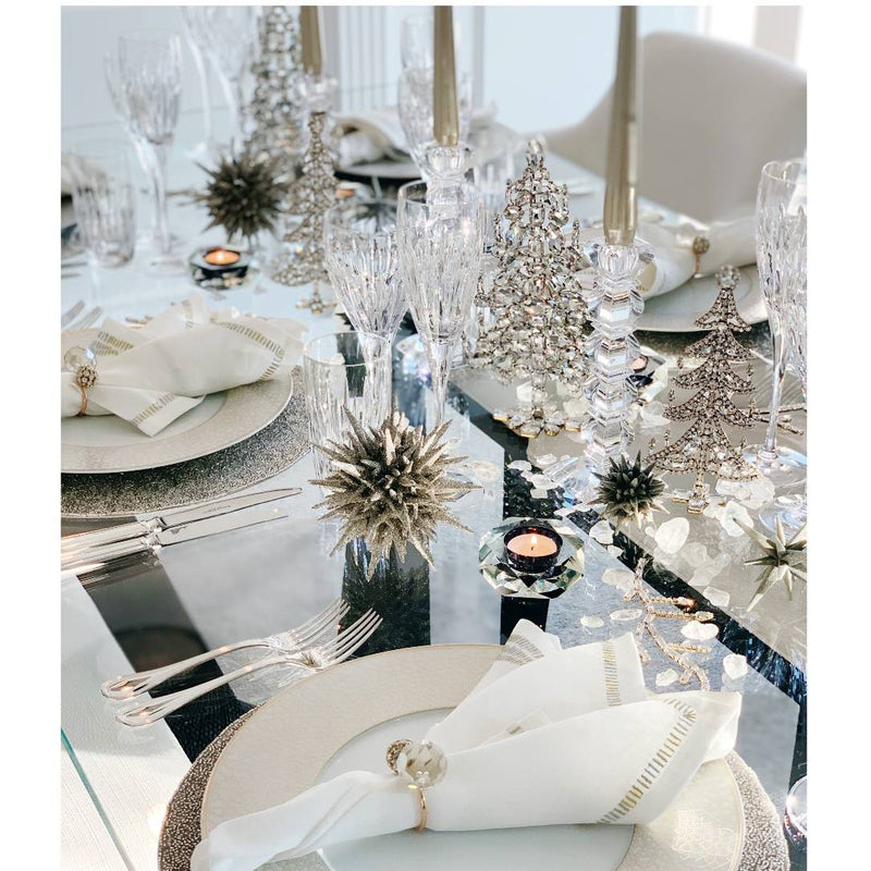 Styled festive table in white and silver featuring bejewelled Christmas tree