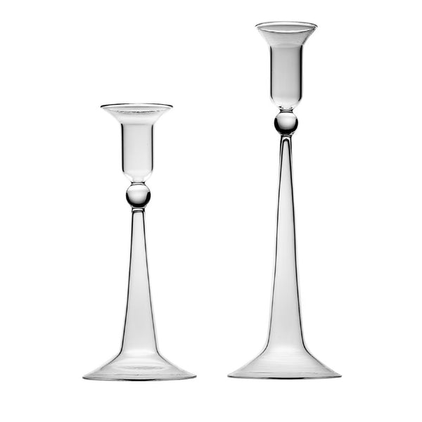 Two clear glass candle holders with a sleek design, one larger than the other, both with a round base and a tapered stem.