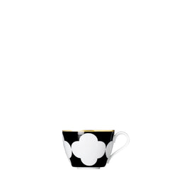 A porcelain coup shaped coffee cup from my china ca d oro collection with black background white quatrefoil pattern and gold rim by sieger furstenberg