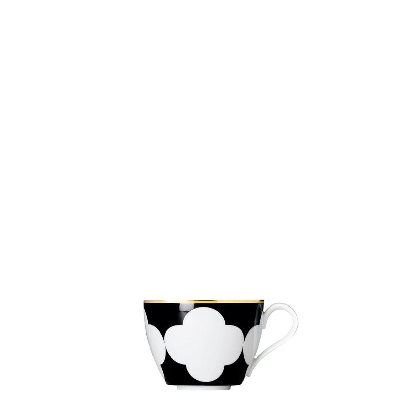 A porcelain coup shaped coffee cup from my china ca d oro collection with black background white quatrefoil pattern and gold rim by sieger furstenberg