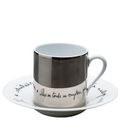 A Raynaud branded coffee cup with a saucer Béatrice featuring a mirrored platinum finish and a quote in French from Jean Cocteau on the saucer.