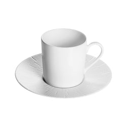A white porcelain coffee cup with a engraved pattern on the cup and a matching white saucer.