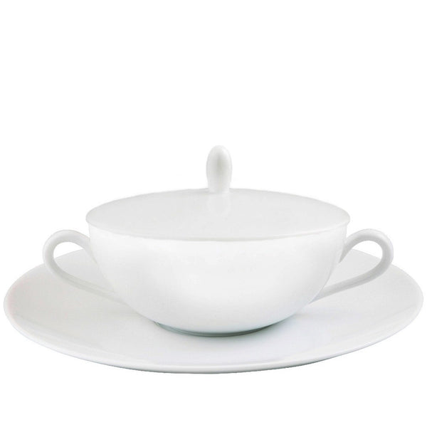 A white porcelain cream soup cup with a lid and saucer, presented against a plain background.