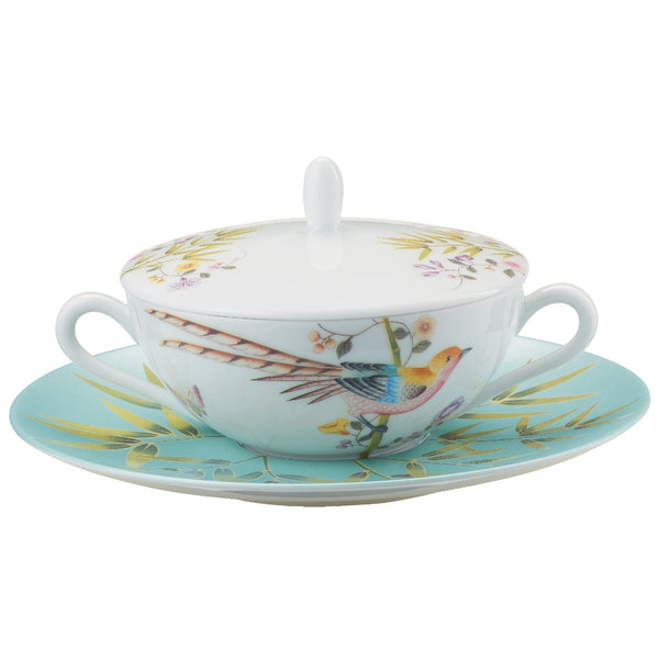 A white porcelain soup bowl with turquoise trim and floral patterns, accompanied by a matching lid and tray.