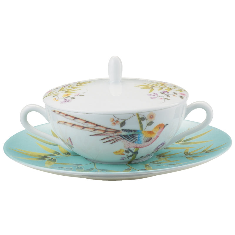 A white porcelain soup bowl with turquoise trim and floral patterns, accompanied by a matching lid and tray.