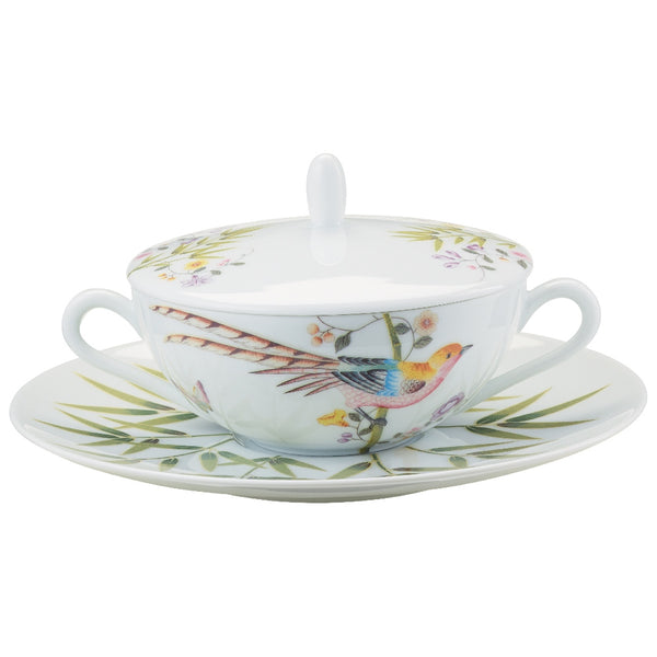 A white porcelain soup cup with floral and bird patterns, accompanied by a matching tray and lid.