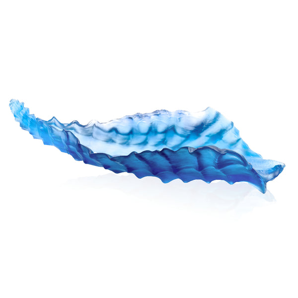 A blue crystal centerpiece sculpture with a wavy, coral-like pattern.