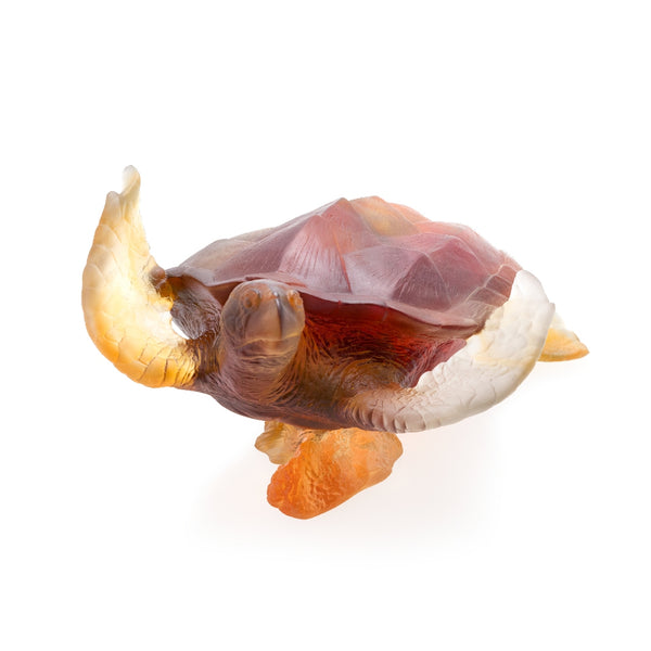 A large crystal sculpture of a sea turtle in amber and gray colors.