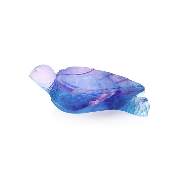 A medium-sized crystal sea turtle sculpture in blue and pink by Daum.