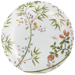 A round porcelain dinner service plate with a floral motif, green leaves, and birds, on a white background with turquoise accents.