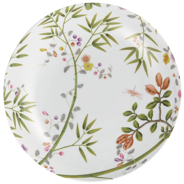 A round porcelain dinner service plate with a floral motif, green leaves, and birds, on a white background with turquoise accents.