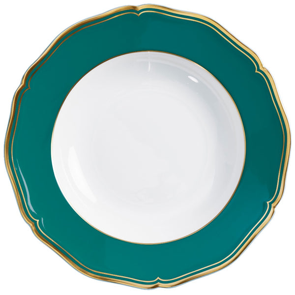 A deep turquoise and gold porcelain plate with a scalloped and gilded edge, featuring a simple central design.