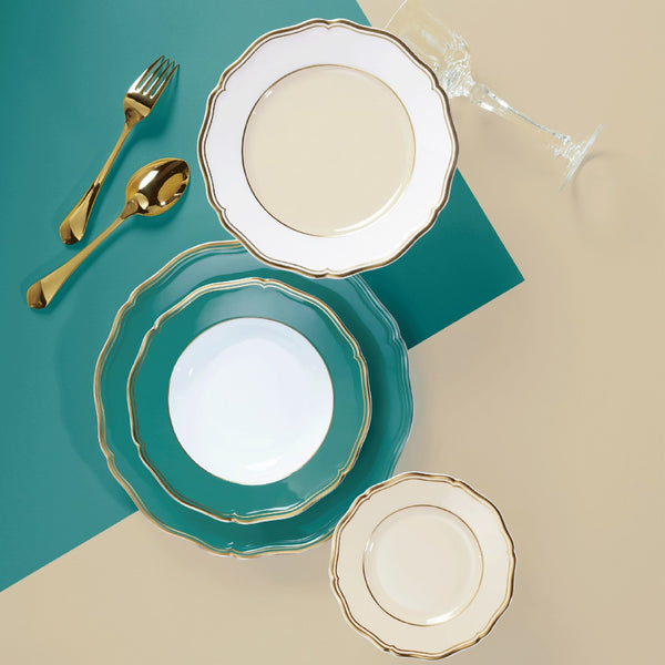Styled collection of Mazurka Turquoise and deep plate with rim by Raynaud in Limoges porcelain, featuring scalloped turquoise border with hand-painted gold.