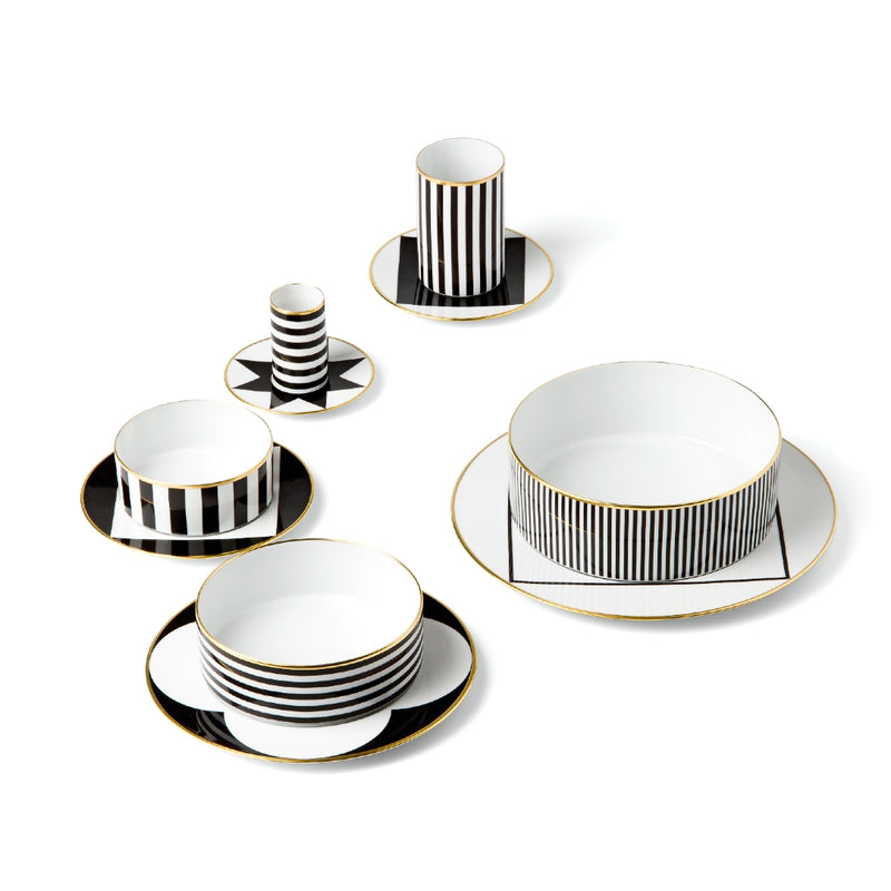 Styled porcelain dessert plate with rim from my china ca d oro collection featuring black geometric border and gold edge by sieger furstenberg on a white background
