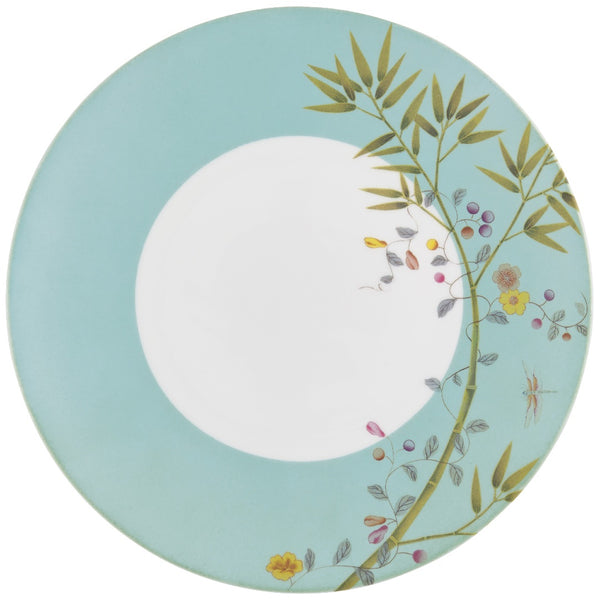 A turquoise porcelain dinner plate with floral and butterfly motifs in brown and green accents.